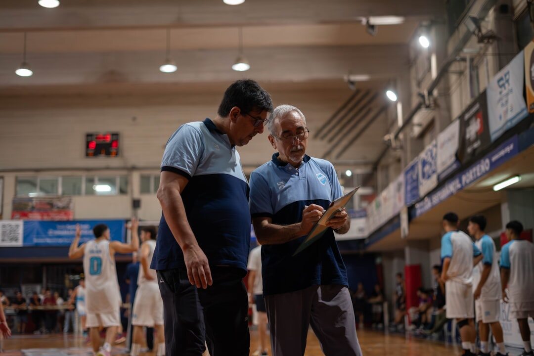 Older man learning to use a tablet with an instructor