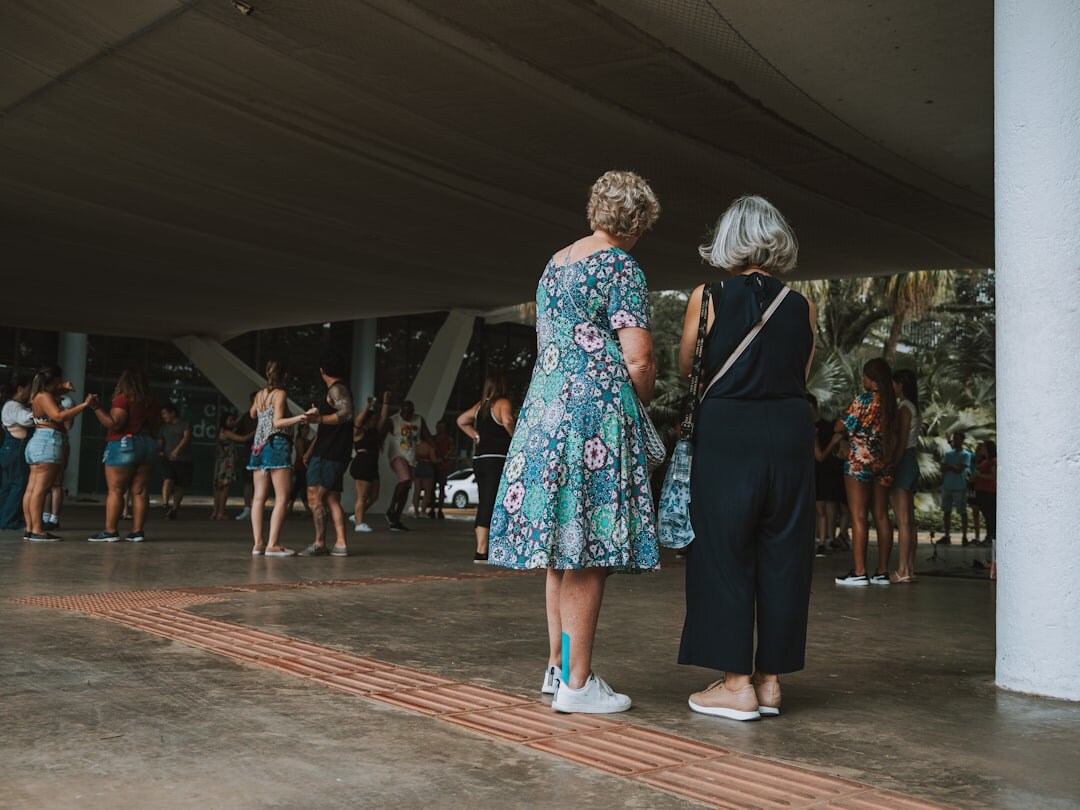 Group of seniors dancing together in a sunlit hall