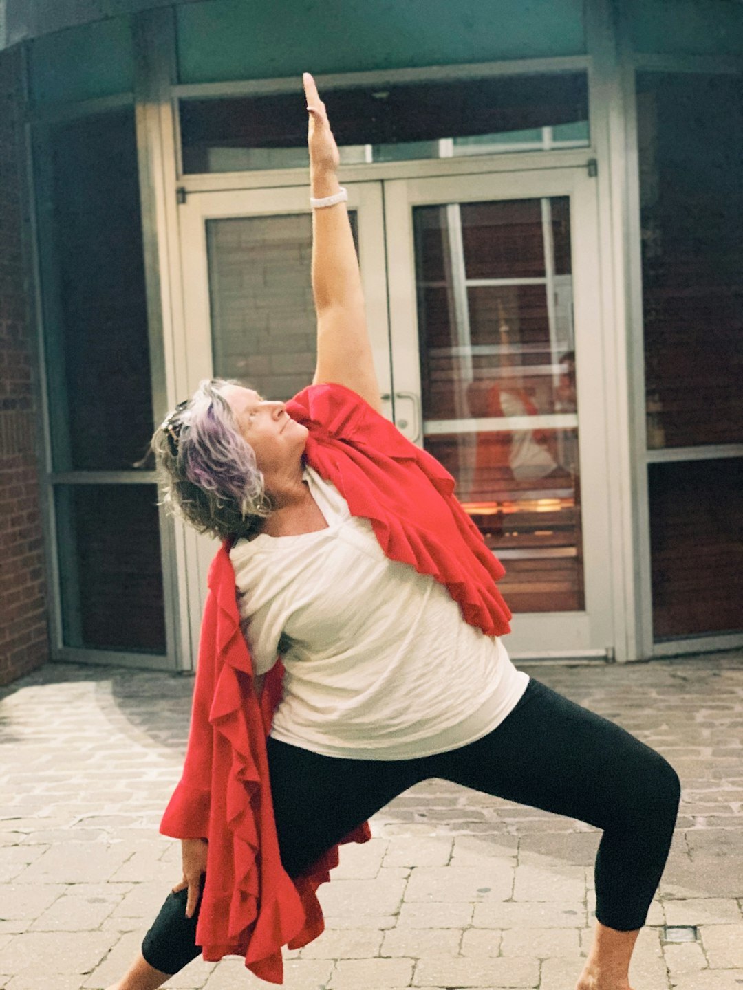 Senior woman practicing yoga in a bright studio
