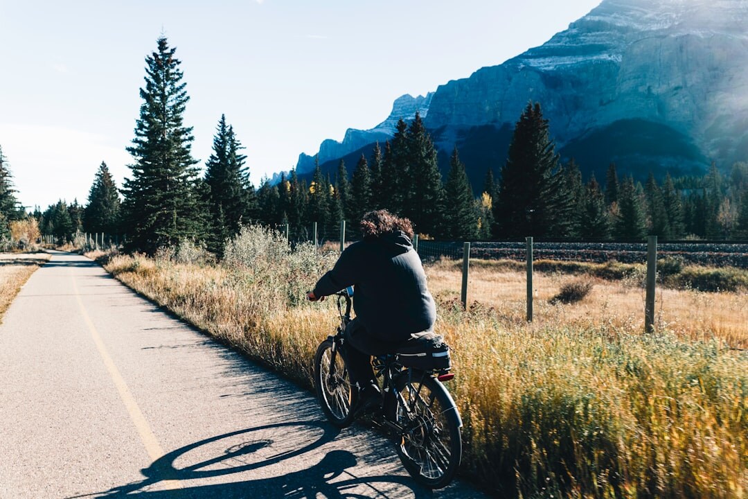 Active senior man cycling on a scenic path